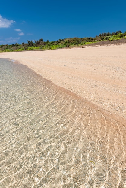 Beautiful crystal clear sea glistening sea coral sand at a tropial beach Okinawa