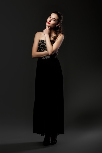 Beautiful curly woman in black dress 