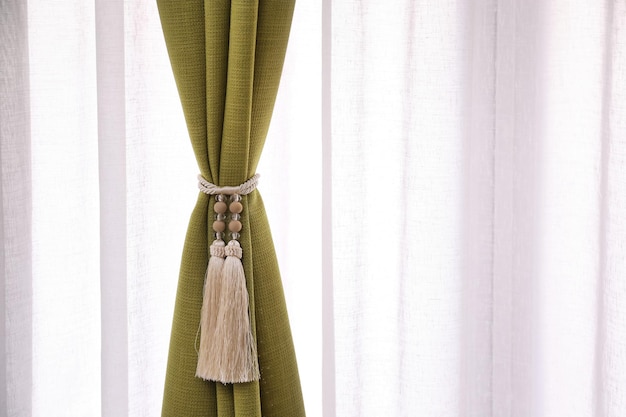 Photo beautiful curtains with tieback indoors closeup