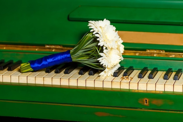 Beautiful and cute bridal bouquet lying on the piano