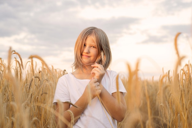 beautiful cute girl in wheat field, happy childhood