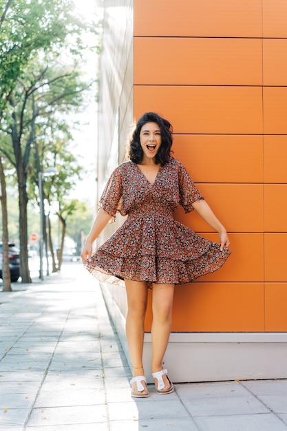 Beautiful cute smiling woman on the street taking a walk in a summer day