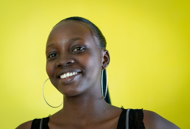 Beautiful dark skin young woman portrait on yellow