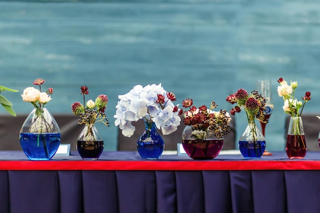 Beautiful decor at the wedding Flowers standing of the Board is painted in turquoise color