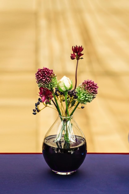 Beautiful decor at the wedding Vase standing on the table The background is light brown