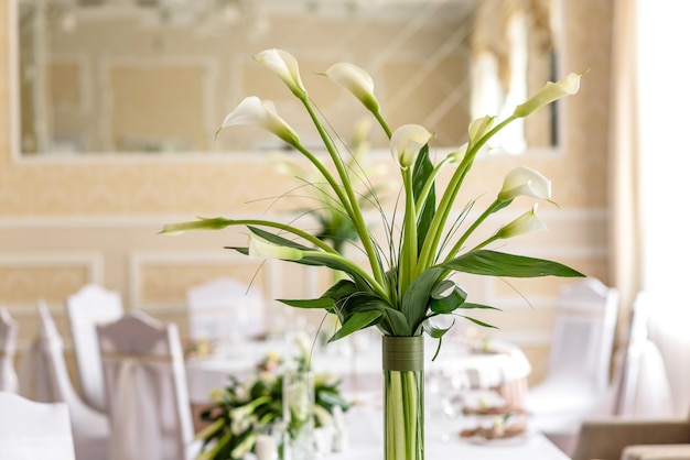 Beautiful decoration of the wedding holiday with flowers and greenery with florist decoration. Preparations for the marriage ceremony