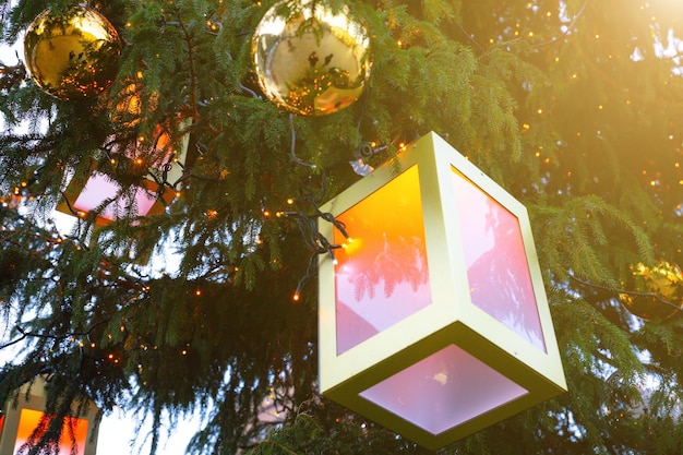 Beautiful decorations on the Christmas tree outdoors Balls and lanterns Festive mood and atmosphere Winter time