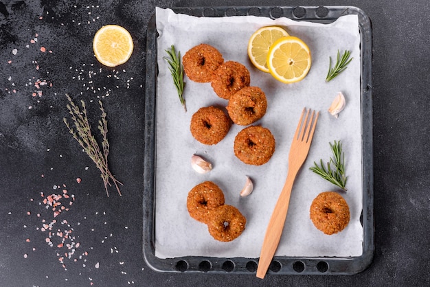 Beautiful delicious fresh chickpea falafel with sauces on a concrete background. Elements of Vegitarian Cuisine