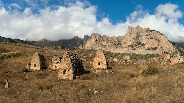 Beautiful dramatic landscape nature view in the mountains Old Ossetian family crypt in the misty mountains Digoria region North Ossetia Russia Panoramic view