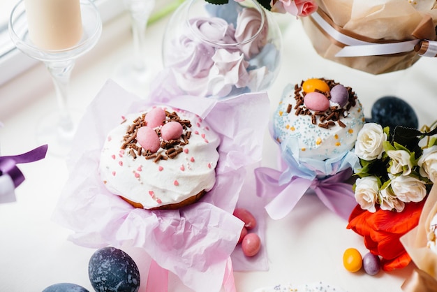 Beautiful Easter cakes with Easter eggs on a decorated light table. Bright Easter holiday.