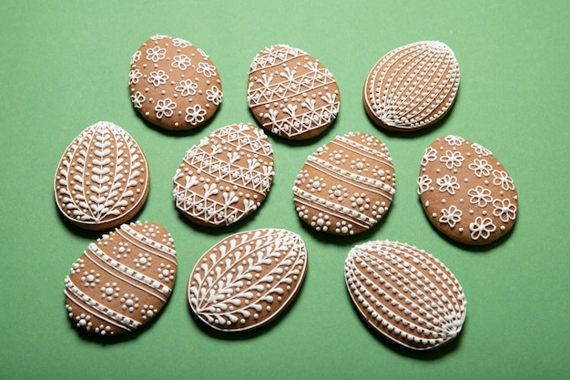 Beautiful easter cookies in the shape of an egg on a green background.