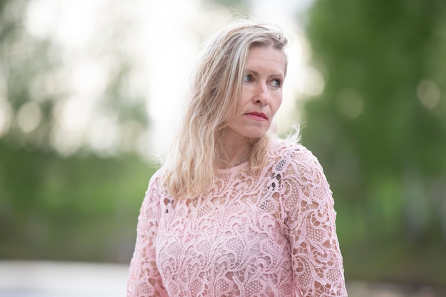 Beautiful elderly blonde woman on a natural background