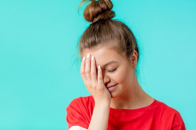 Beautiful embarrased woman covering with hand her eye