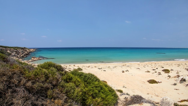 Beautiful empty unspoiled fine sand beach with no people, view from top of the hill to azure calm sea. Karpass (Karpaz) region, northern Cyprus.