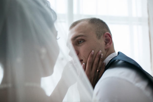 Beautiful European bridal couple in the hotel room