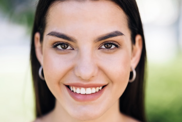 Beautiful face of tender attractive woman staying outside