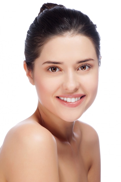 Beautiful face of young adult woman with clean fresh skin 