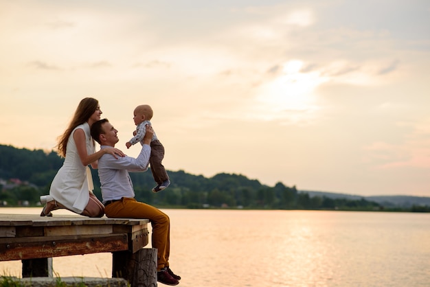 Beautiful family having fun near the lake