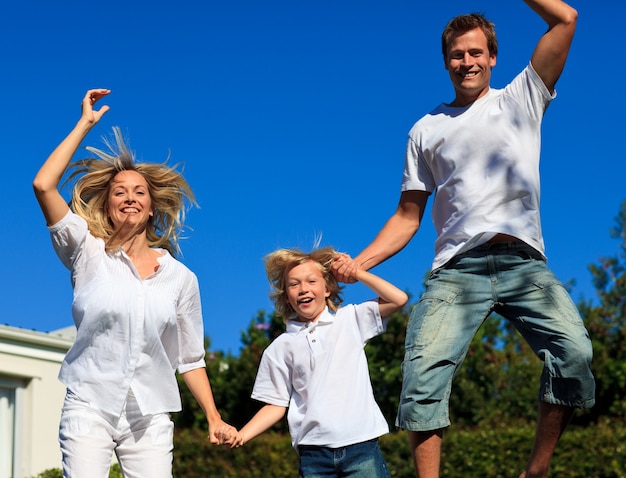 Beautiful family jumping in the air