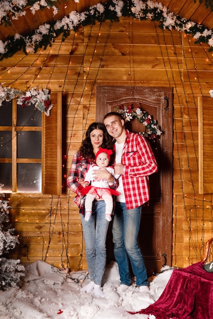 Beautiful family with their baby in front of a house