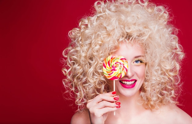 Beautiful fashionable blonde girl in retro style with voluminous curly hairstyle