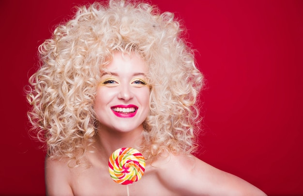 Beautiful fashionable blonde girl in retro style with voluminous curly hairstyle