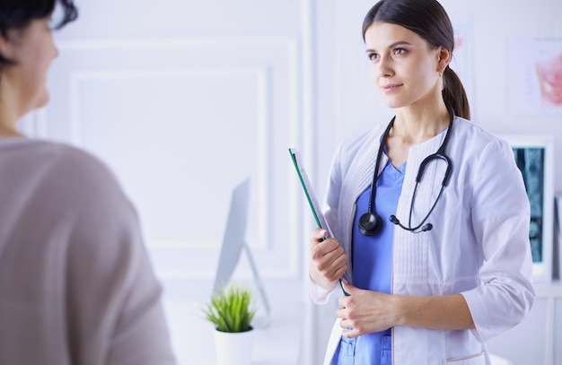 Beautiful female doctor explaining medical treatment to a patient