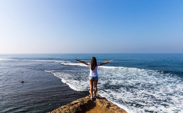 Beautiful female enjoying a sea view on a sunny day