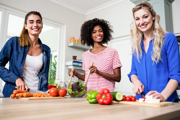 Beautiful female friends preparing food