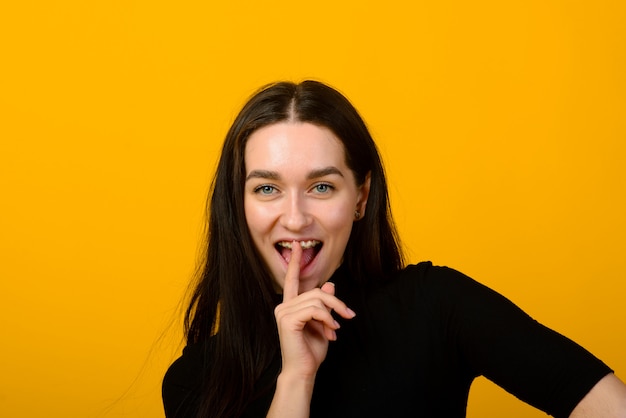 Beautiful female front portrait isolated on yellow studio backgroud