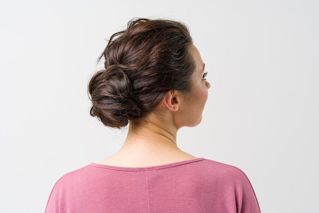 Beautiful female hairstyle rear view the womans hair is arranged in a bun