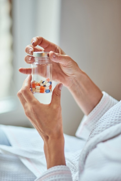 Beautiful female hands holding bottle with vitamins