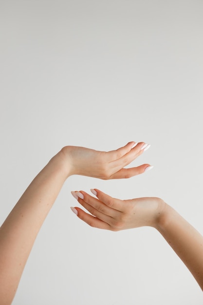 Beautiful female hands on a white background