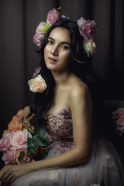 Beautiful female model High fashion portrait sits in a light studio