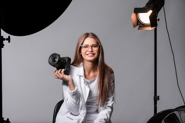 Beautiful female photographer in studio