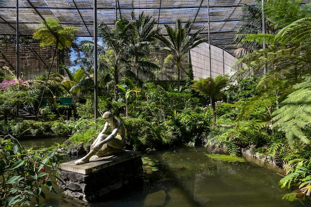 Beautiful female statue in greenhouse