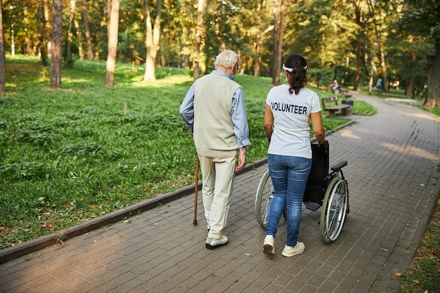 Beautiful female walking with older male in the outdoors