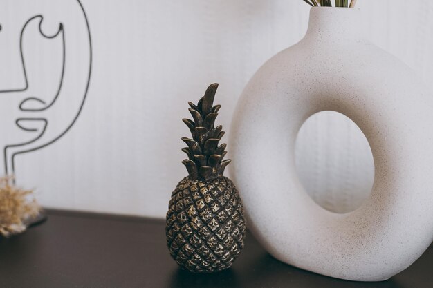 A beautiful figurine of a small black pineapple stands on the table as decor