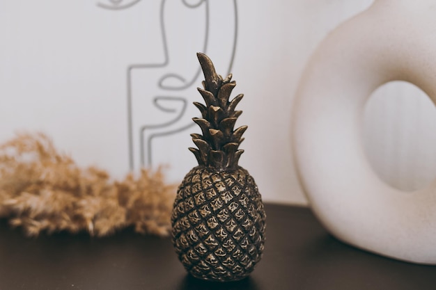 A beautiful figurine of a small black pineapple stands on the table as decor