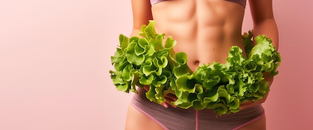 A beautiful fit healthy woman with fair skin wearing short jeans showcasing her hips and abdomen with green leafy vegetables wrapped around her hips