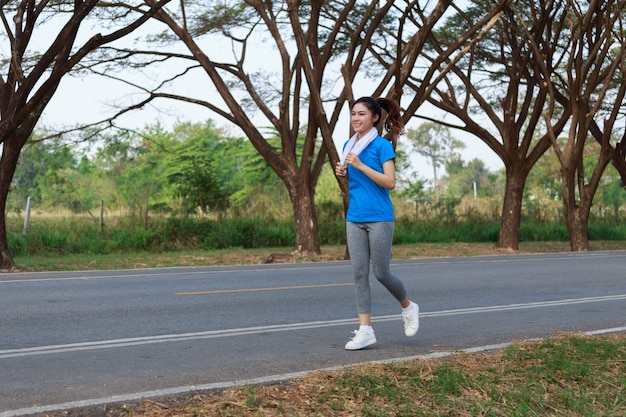 beautiful fitness woman running in park