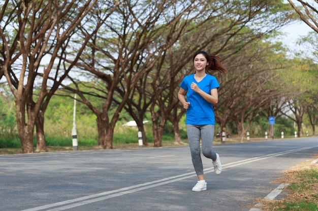 beautiful fitness woman running in park