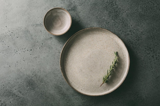 Beautiful flat ceramic plate with rosemary