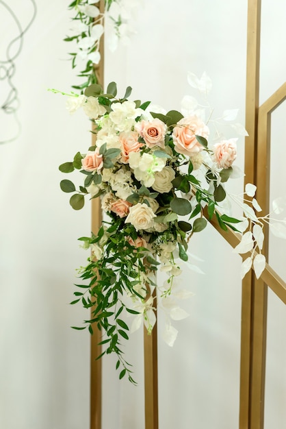 Beautiful floral compositions in the restaurant for the wedding ceremony. Solemn ceremony of painting the groom and bride