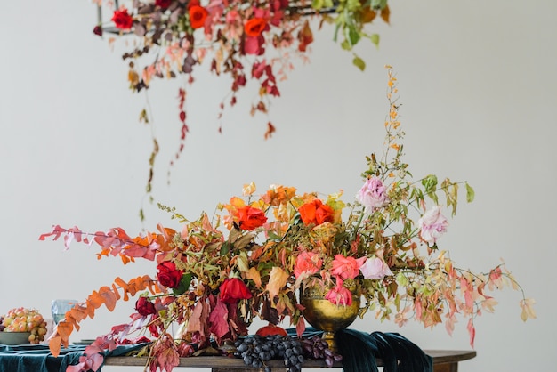 Beautiful flower composition with autumn orange and red flowers and berries