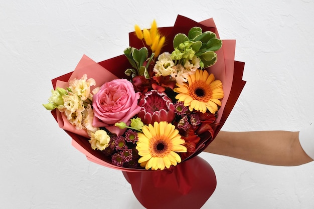 Beautiful flowers for holiday Woman with beautiful flowers in hands indoors background bouquet of flowers for flower shop