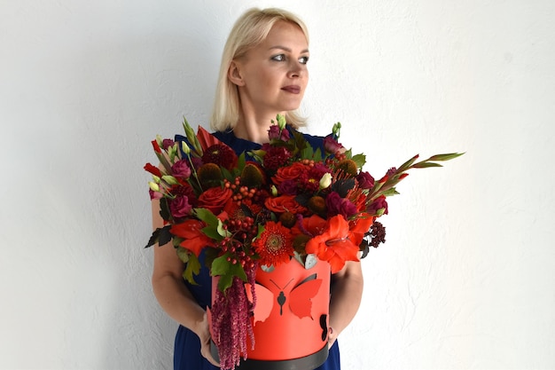 Beautiful flowers for holiday Woman with beautiful flowers in hands indoors background bouquet of flowers for flower shop