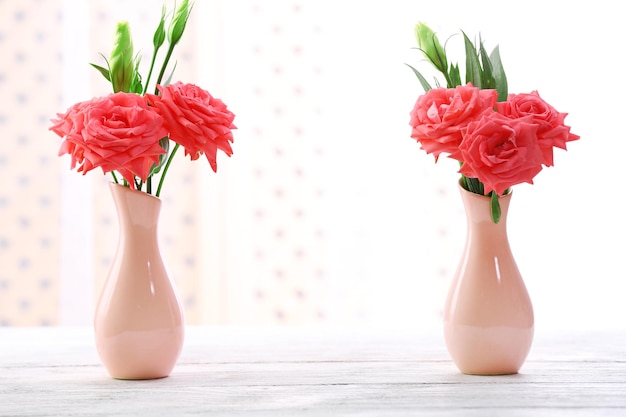 Beautiful flowers in vase with light from window