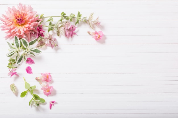 Beautiful flowers on white wooden table