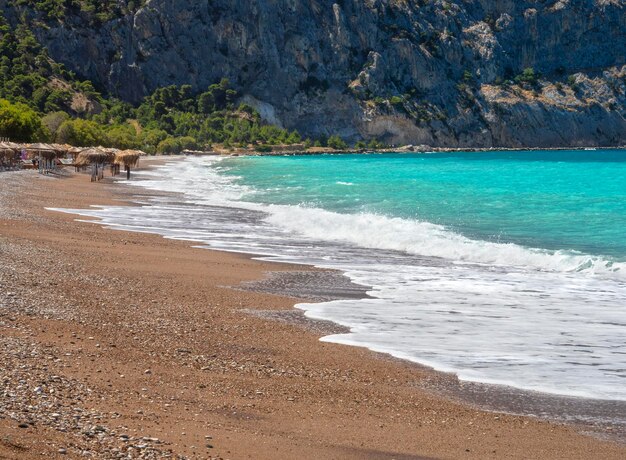 Beautiful foamy waves on the beach Psatha in the Corinthian Gulf and the Ionian sea in Greece